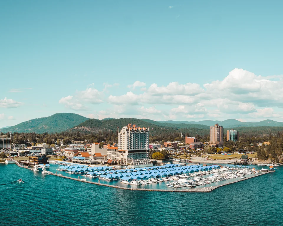 The Coeur d’Alene Resort and marina along the lake, with forested hills beyond.